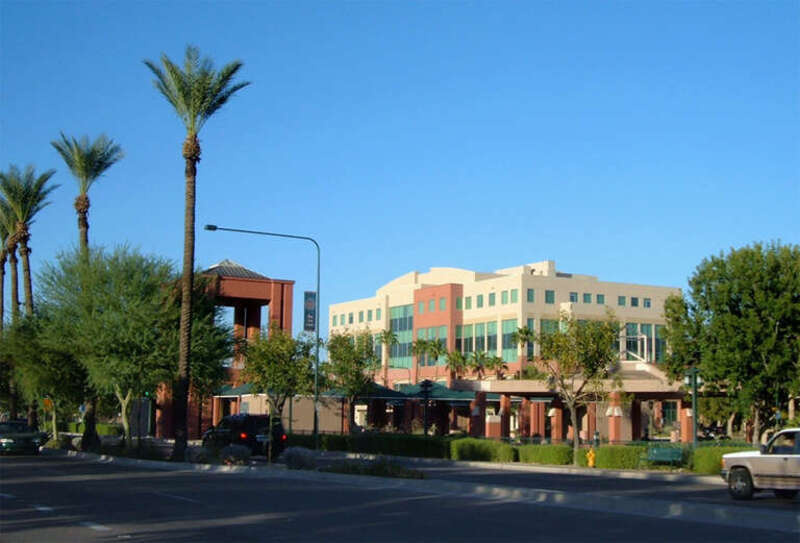 Photograph of the downtown area of Chandler, Arizona. Taken from the west side of the sidewalk about 100 feet north of the intersection of Boston Street and Arizona Avenue. The light-colored building is the Chandler Office Center. This photograph was
