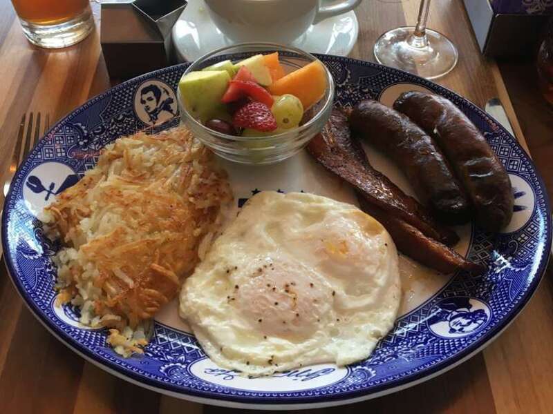 A typical farmer's breakfast in the United States. One typically contains two fried or scrambled eggs, hash browns, chicken or pork sausages, glazed bacons and fruits.
