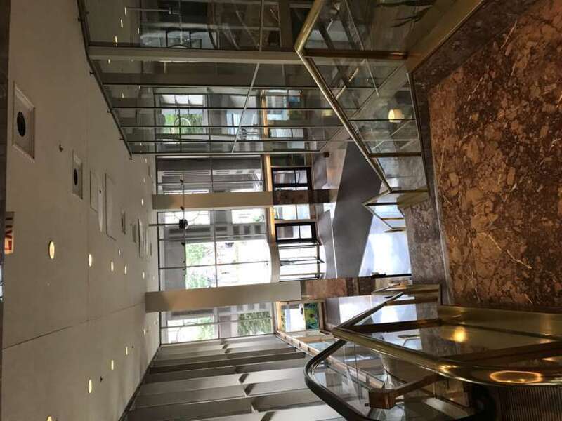 Looking down the stairway of the main lobby of Monarch Place in Springfield, Massachusetts, noted here as the general lobby, as opposed to the Sheraton Monarch Place Hotel which is a tenant in another part of the building.