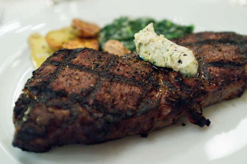 Hickory Grilled NY Strip with roasted fingerling potatoes, local creamed  spinach and black peppercorn butter.  This was a great steak.