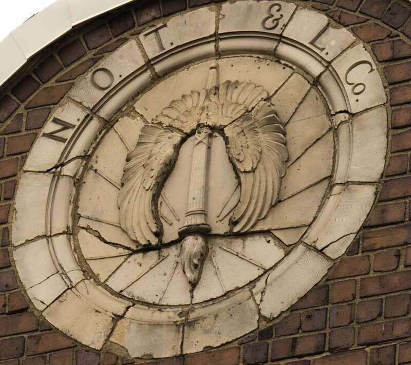 This medallion appears on the Northern Ohio Traction &amp; Light building, 42 N High Street, Akron, Ohio.  It appears the torch has been turned upside down at some point.