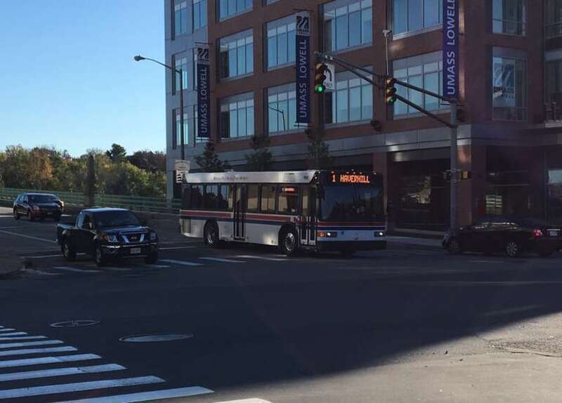 MVRTA route 1 bus on Main Street (coming off the Basiliere Bridge) in Haverhill in October 2017. At right is the Harbor Place building of UMass Lowell.