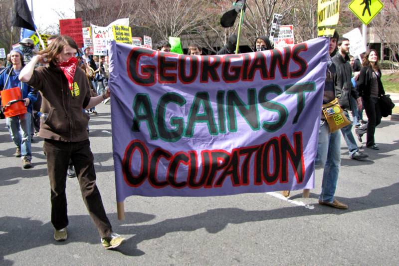 Two people carry a banner reading "Georgians Against Occupation" down South Clark Street in Arlington, Virginia's Crystal City neighborhood.
The March on Crystal City (formally the March on the Pentagon) was a protest against the wars in Iraq and