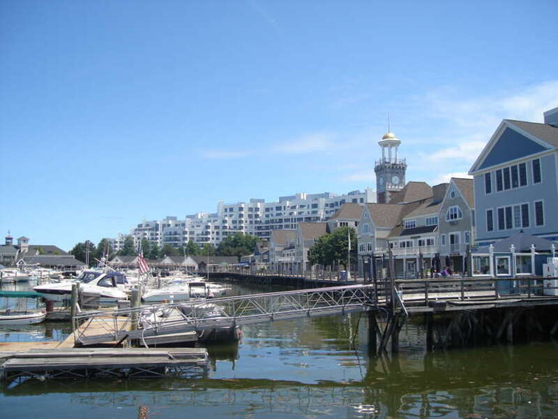 The marina, boardwalk, clock tower and shops at Marina Bay in Quincy, Massachusetts, with the Marina Point condominiums in the background.