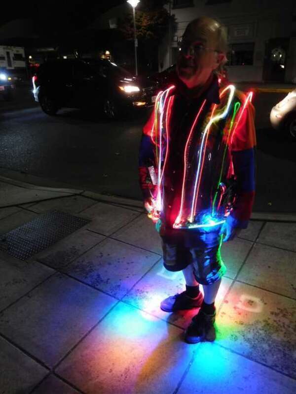 My friend Mark Allyn who recently moved here from Hillboro, Oregon. Worked for Intel and has now "escaped" to a life of artistic retirement. Loves walking around glowing up our city of subdued excitement.  I like the way it lights up the sidewalk. —