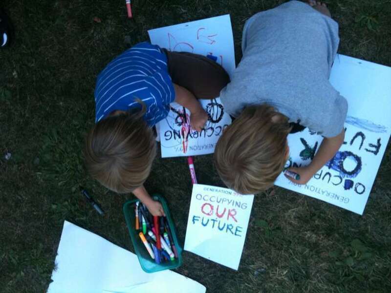 Kids coloring "Operation 99% Occupying Our Future" signs. Oakland Public Library kids gathering.