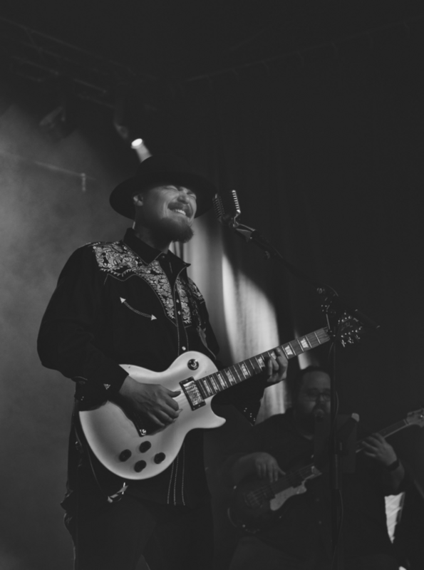 This photograph was taken by Rose "Wednesday" Torres on May 3, 2022 capturing Pat Ryan Key performing at George’s Majestic Lounge in Fayetteville, Arkansas.