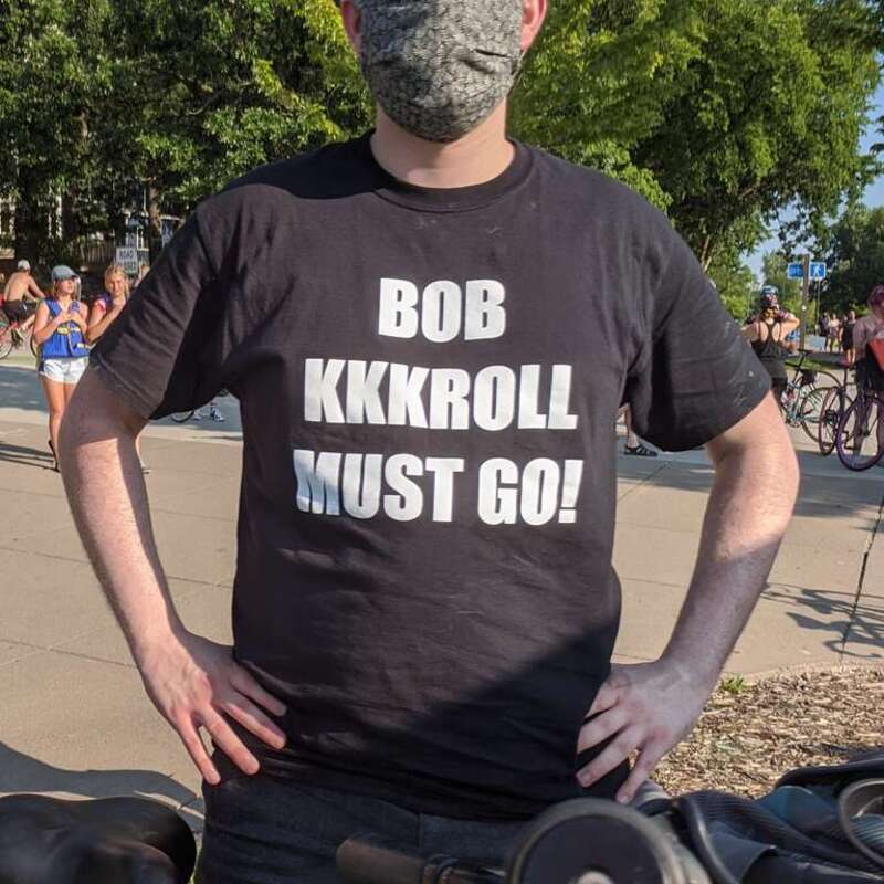 Protestor in Minneapolis wears a shirt reading 'Bob KKKroll Must Go.' Taken on July 4th roll-through protest rally at Bde Maka Ska, Minneapolis, Minnesota.