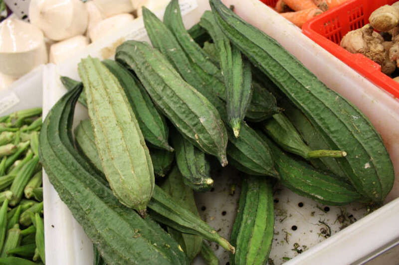 Ridged gourd. Sinqua. Aka loofah, like the exfoliating sponge. Peel the skin and ridges, and cut the soft inside lengthwise. As you might expect with a sponge, soaks up flavors well. Bladholm notes it goes well with green peppers, peas and tomatoes.