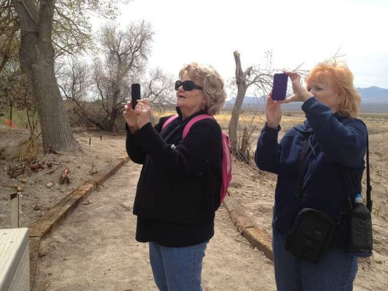 Marilyn Parker, left, and Liz Reeder, right, use their smartphone cameras at Desert National Wildlife Refuge in New Mexico to take and share photos during a special event with a local photographer and artist. (USFWS)