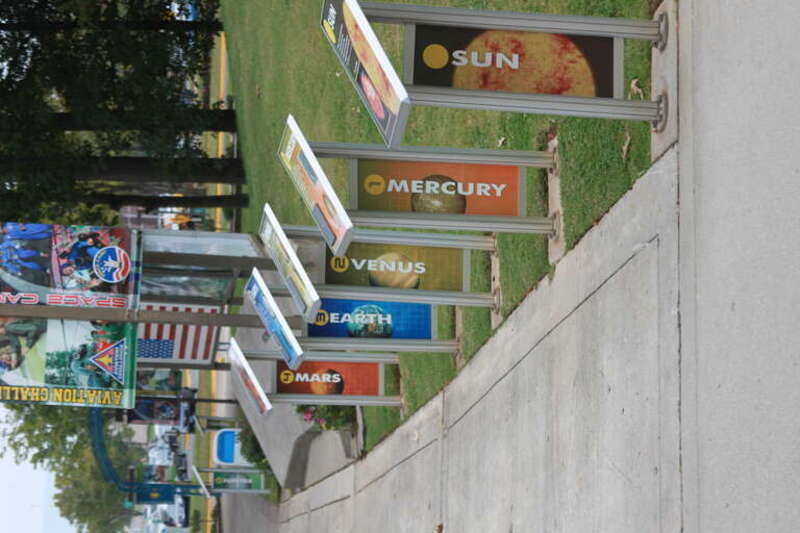The walkway into the United States Space &amp; Rocket Center includes a display for each planet (and the sun), stretching approximately 590 ft (180m) from the Sun to Pluto, spaced appropriately.  Hemispheres on each display represent the planets,