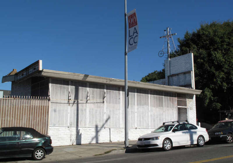 Tall bike displayed above a roof in East Hollywood, Los Angeles.