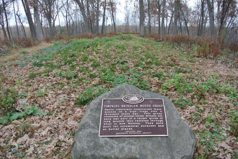 The marker and one of two linear mounds in the Tompkins-Brindler Mound Group in Woodland Park in Monona, Wisconsin