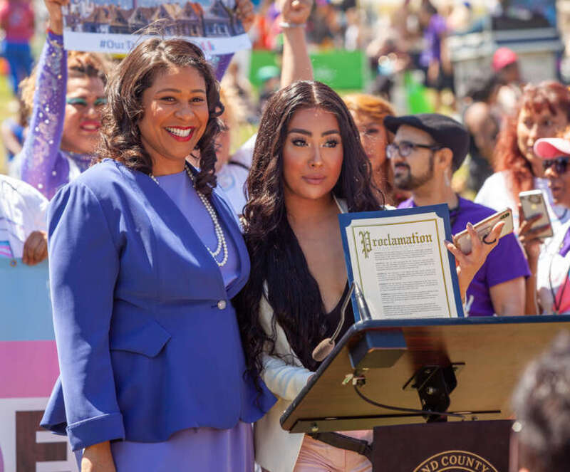 San Francisco mayor London Breed poses alongside Melanie Ampon at a press conference at the 2019 San Francisco Trans March. Mayor Breed had just announced a proclamation declaring June 28, 2019 to be "Trans March Day".