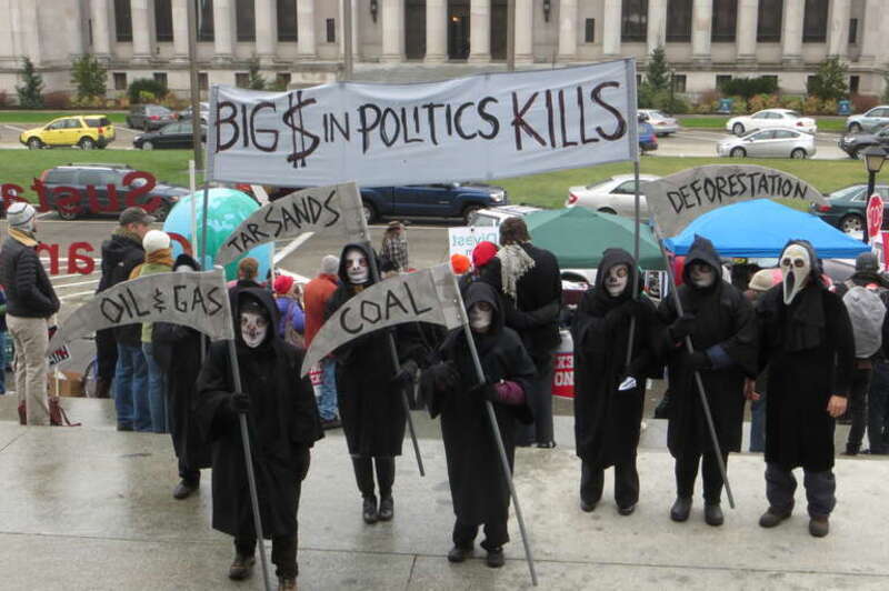 Protest at the Legislative Building in Olympia, Washington (2013.01.14). Reapers. "Big $ in politics kills", "Tar Sands", "Oil &amp; Gas", "Coal", "Deforestation".