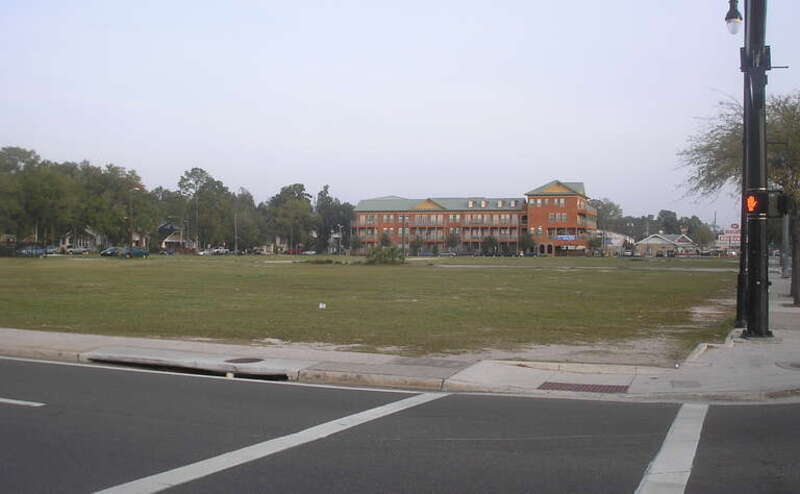 View looking north from the main entrance of the University of Florida, a now empty lot that once had thriving, landmark businesses that were torn down to make way for denser development with millions of dollars of tax incentives by the Gainesville