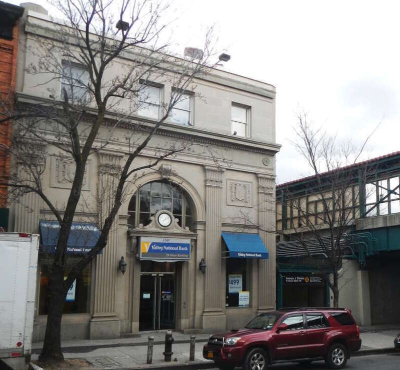 Looking northeast across Avenue J at bank on a cloudy afternoon.