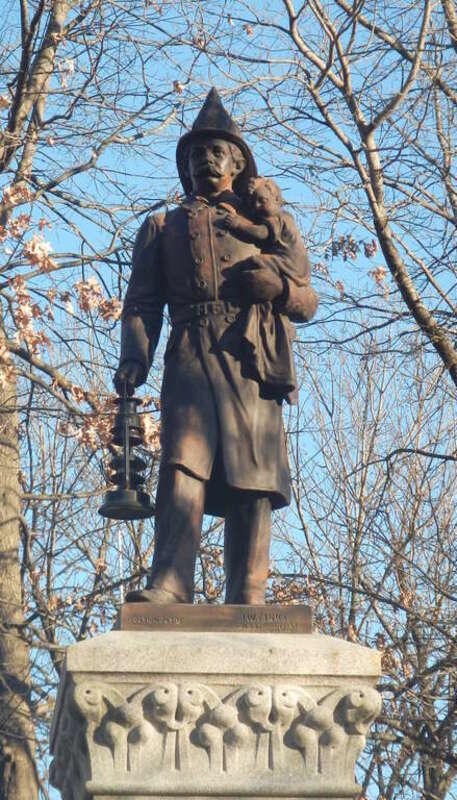 Looking east at fireman memorial on a sunny afternoon.