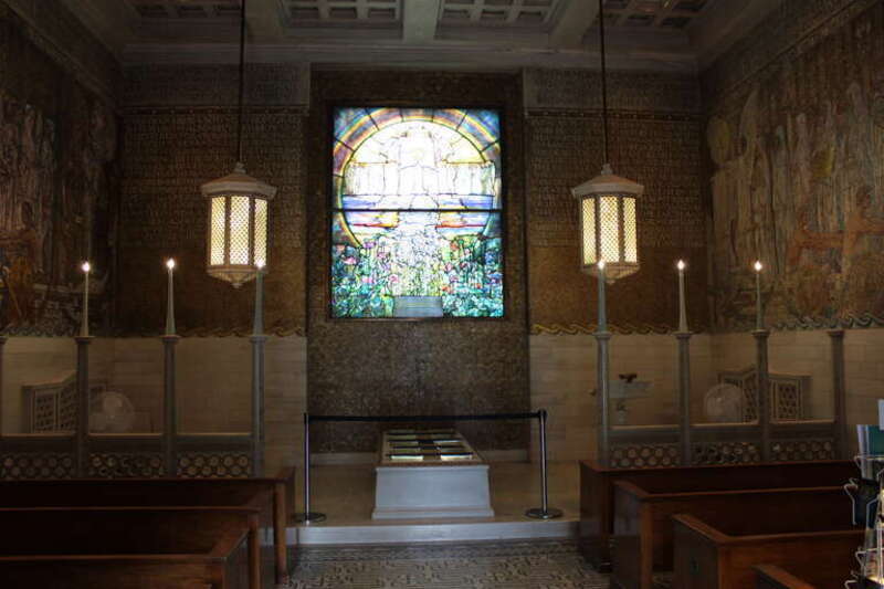 Interior of the Wade Memorial Chapel, with the stained glass window " The Flight of Souls " centerpiece.