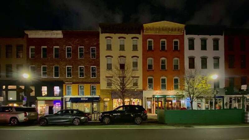 Washington Street - the main drag of downtown Hoboken, New Jersey - is lined on both sides with 19th-century brick rowhouses most of whose ground floors have been converted to shops and restaurants. As seen between 4th and 5th Streets on a November