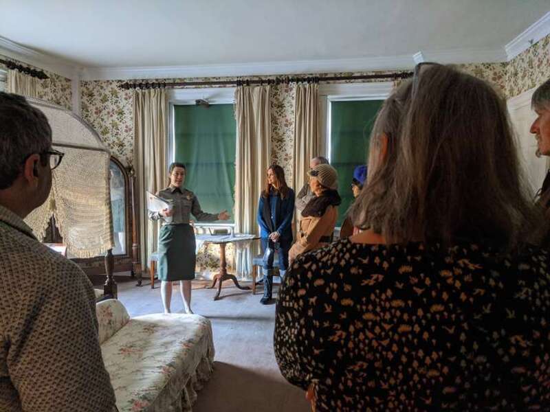 ranger talks with group of visitors in large historically furnished bedroom
Keywords: RM209; House Tour