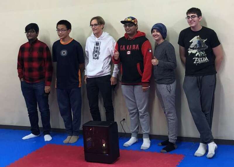 TSY Founder Vismay Patel (Pictured in Canada Hoodie) in front of the computer they donated in 2021