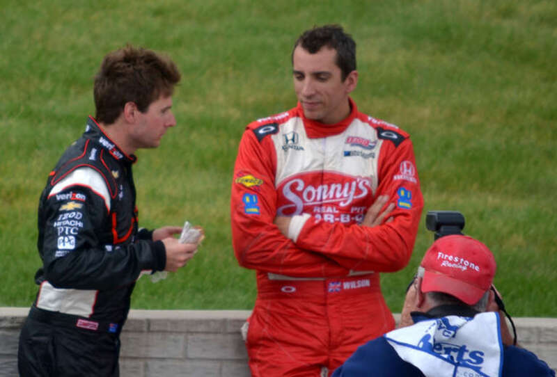 Will Power and Justin Wilson chat during the stoppage to the 2012 Detroit Belle Isle Grand Prix