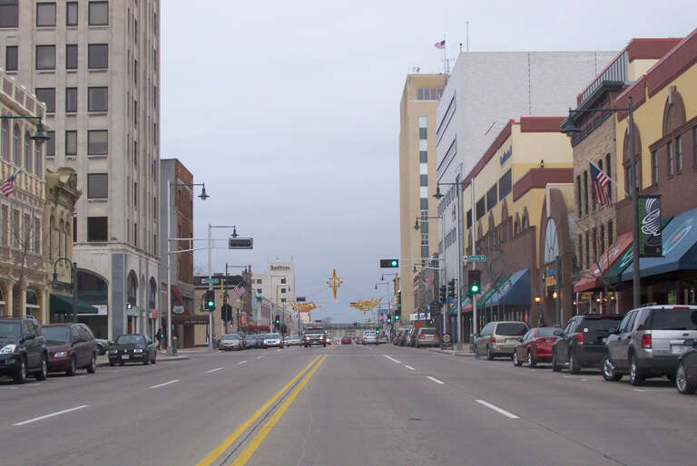Looking west at downtown Appleton, Wisconsin, USA. Cropped from the original.

The Zuelke Building is the tall building on the left just past the nearest intersection (Oneida Street).