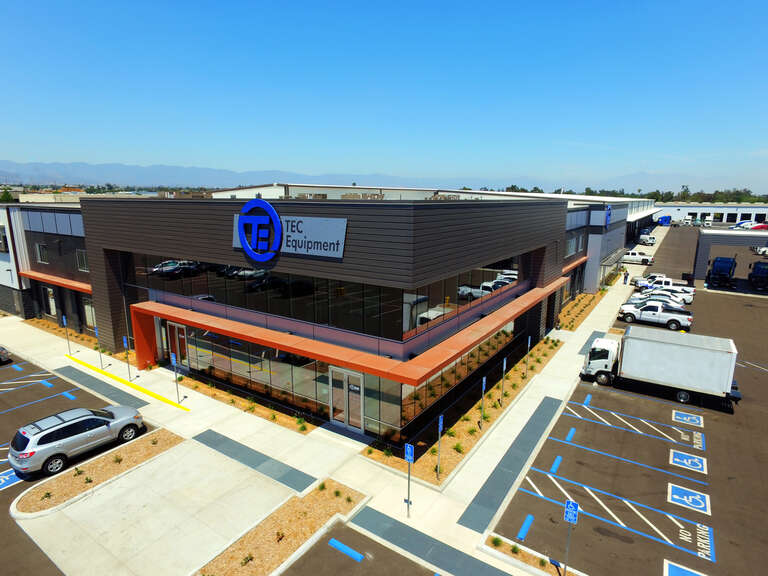 TEC Equipment Fontana Trucks Location. Aerial shot. Prominently features building with company logo on the exterior wall.