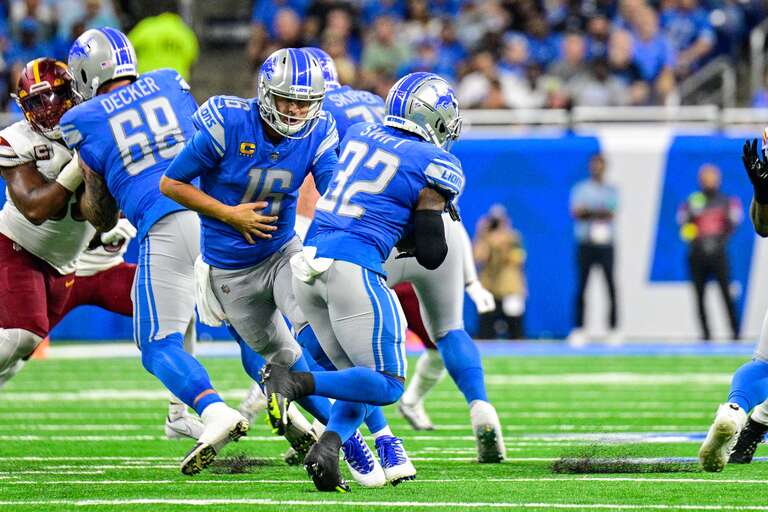 Detroit Lions quarterback, Jared Goff, hands the ball off to running back, D'Andre Swift, in a game against the Washington Commanders at Ford Field, Detroit, MI on September 18, 2022.