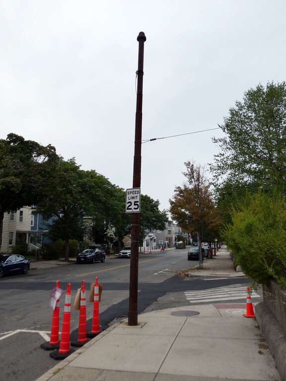 An old trolley wire pole on Broadway near Teele Square, seen in September 2022. It was in use until trackless trolley service ended on routes 87, 88, and 89 on March 30, 1963.