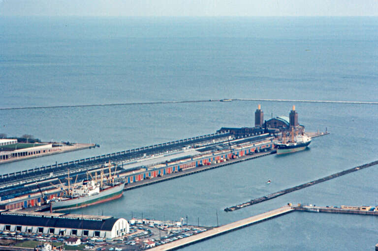 Navy Pier from the Prudential Building.  It was built in 1914-1916, and is about 3,300 ft (1,000 m) long.  When I was young, people said that it was a mile (1.6 km) long.  It was a Chicago city pier, and apparently never an official Navy facility.