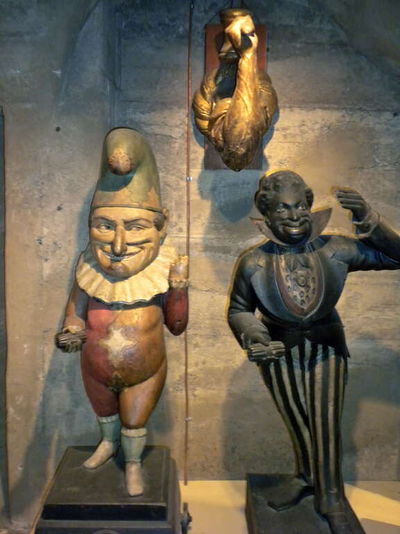 19th century cigar store figures from Mercer Museum in Doylestown, Pennsylvania.  Not all such figures were "Cigar Store Indians".  The middle figure, which is hard to see here, is an arm and hammer.