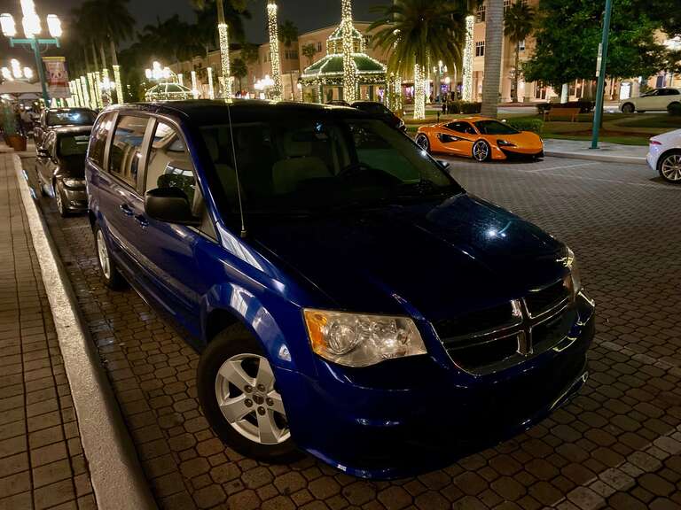 Dodge Grand Caravan (RT) photographed at night parked in Mizner Park, Boca Raton, Florida. Front view of this minivan finished in Indigo Blue.