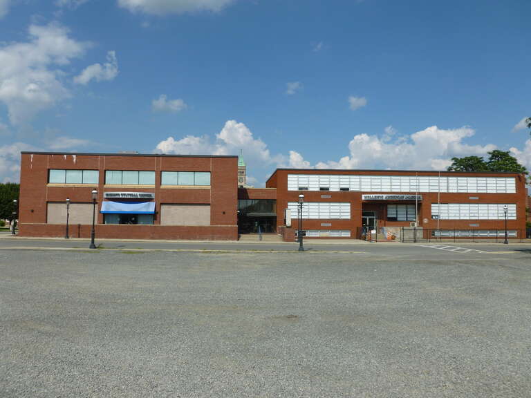 The Hellenic Cultural Center and Hellenic American Academy, located at 41 Broadway Street, Lowell, Massachusetts.  Southeast (front) sides shown.  Lowell City Hall is visible in the background at left.