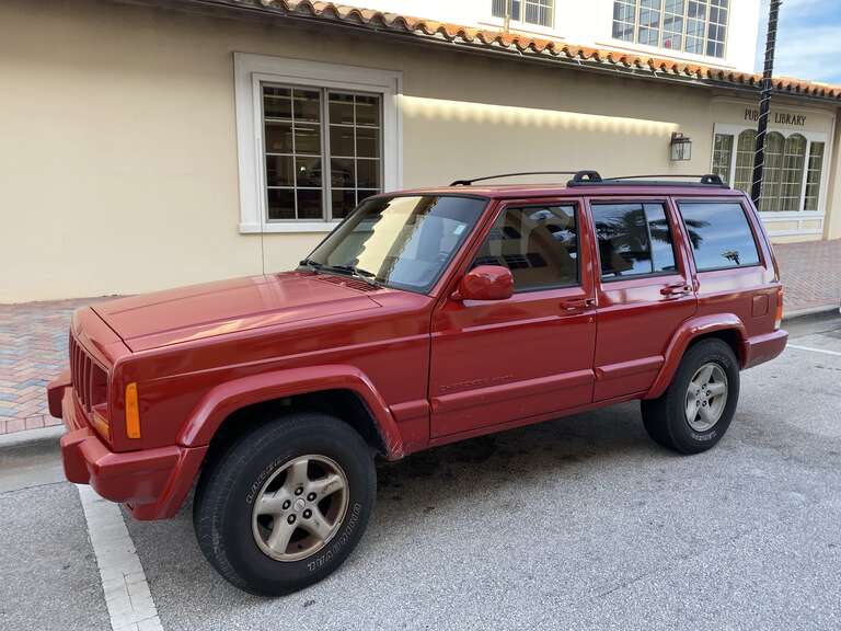 Jeep Cherokee XJ (1997–2001) 4-door. Left side view. This SUV repainted all red. Photographed in Florida.