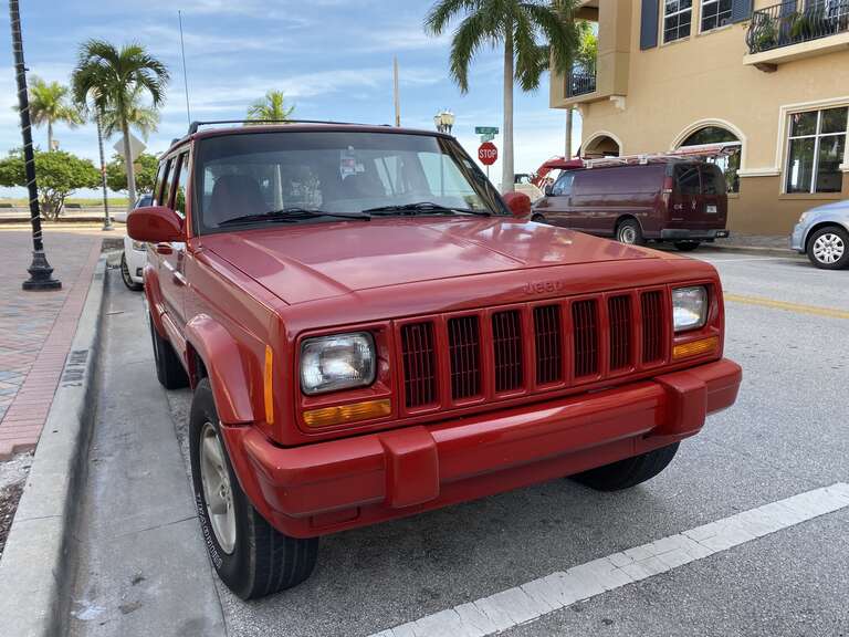 Jeep Cherokee XJ (1997–2001) 4-door. Front view. This SUV repainted all red. Photographed in Florida.