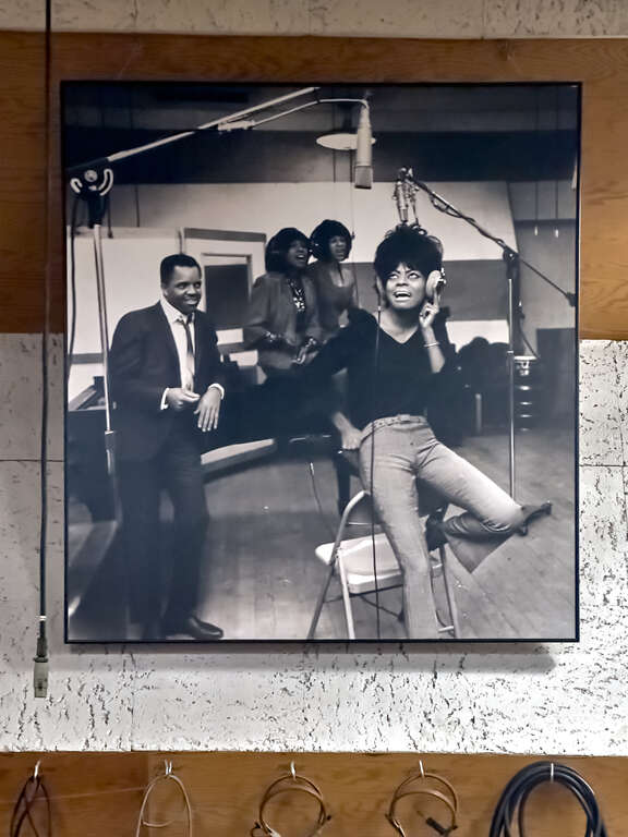 Diana Ross and the Supremes recording inside Studio A while Barry Gordy, Jr. looks on.