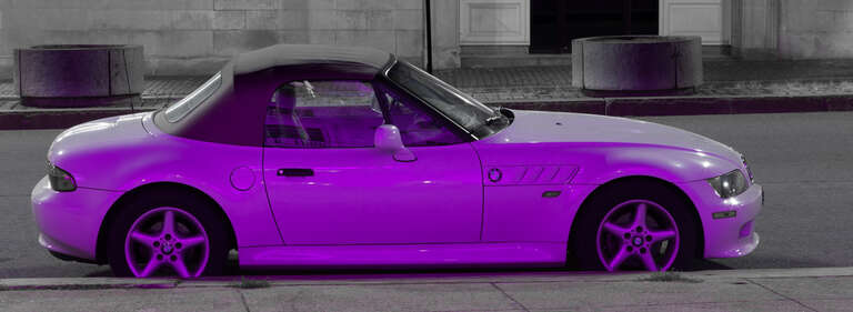 This car was parked at the curb in front of the Portland City Hall that was illuminated with "pink" light in support of Breast Cancer Awareness during the month of October.  From the other side the car is white. as seen in my photo from two days ago.