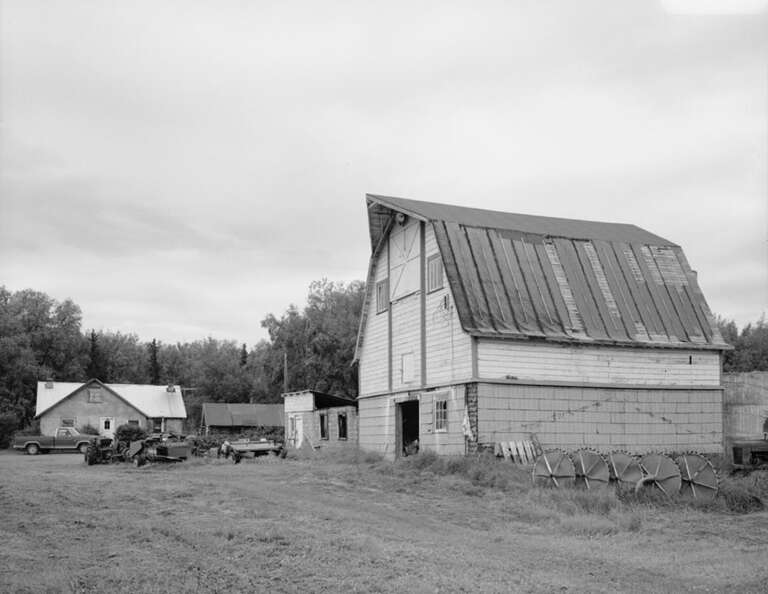 Southern view of the Raymond Rebarchek Colony Farm, a farm located along the Glenn Highway south of the city of Palmer in the Matanuska-Susitna Borough of the U.S. state of Alaska.  Built in 1935, the farm was added to the National Register of