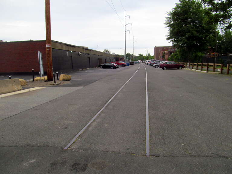 Rails of the Saugus Branch embedded in a parking lot in Malden, Massachusetts