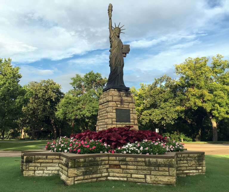 This is a scale model replica of the Statue of Liberty with pedestal and star shaped basin, about 20 feet tall, donated by the Boy Scouts of America (BSA) as part of the nationwide Strengthen the Arm of Liberty project of 1950, located in Oakdale