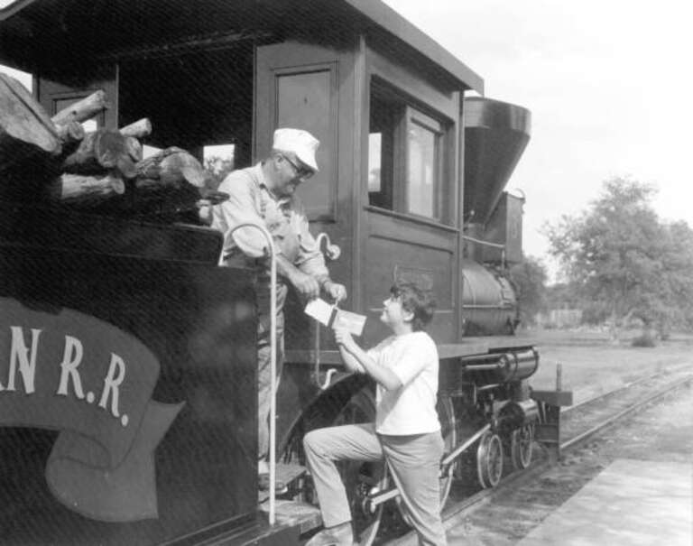 Local call number: c670175Title: Young visitor gets autograph from train engineer at Pioneer City: Davie, FloridaDate: 1967Physical descrip:  1 photoprint; b&amp;w ; 4 x 5 in.Series Title: Department of Commerce collectionGeneral note: Pioneer City