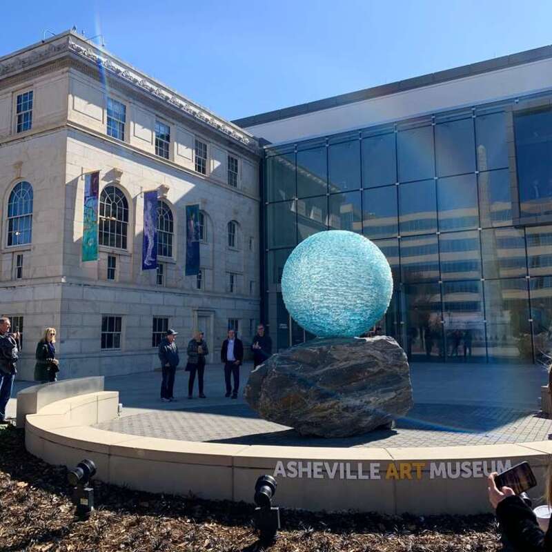"Reflections on Unity" is a chiseled glass orb sculpture by the artist Henry Richardson. It is in the public plaza in front of the Asheville Art Museum in Asheville, NC.