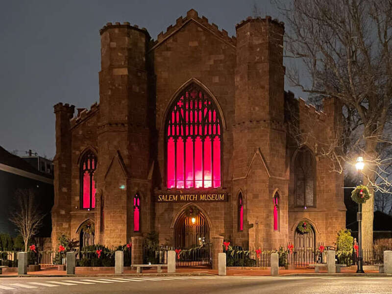 The Witch Museum in Salem, Massachusetts, shortly after dusk, in January 2021. It is still adorned with its holiday decorations.