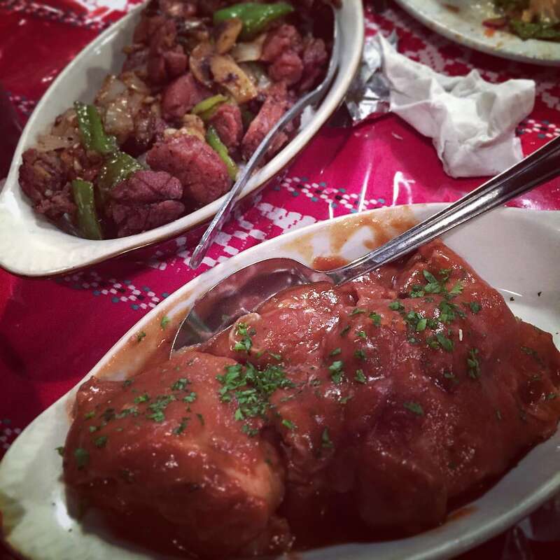 Rabbit in red wine (foreground) and sweetbreads sautéed in garlic, peppers, mushrooms and onions at Louis' Basque Corner, Reno, Nevada