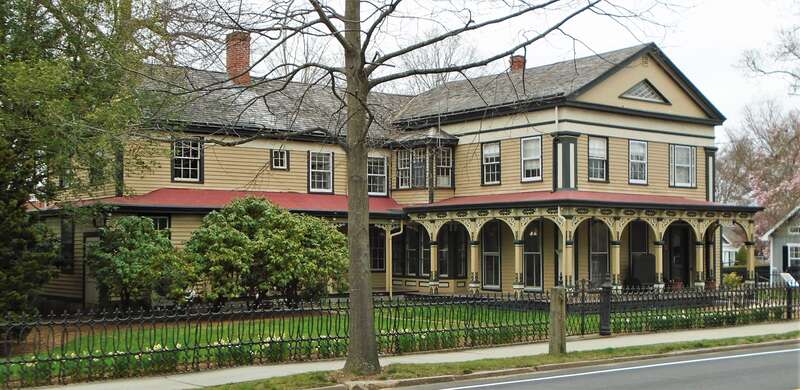 The Clark Greenman House at 75 Greenmanville Avenue in Mystic, Connecticut was built in 1841 in the Greek Revival style for Clark Greenman, the second oldest of three brothers who founded the George Greenman &amp; Co. shipyard. The porches with their