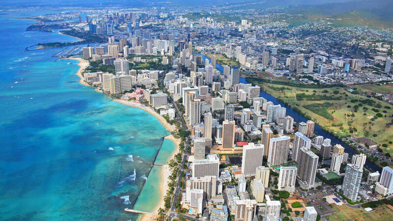 An aerial view of Waikiki and Honolulu from a doors off ride with Genesis Aviation Helicopter Tours.