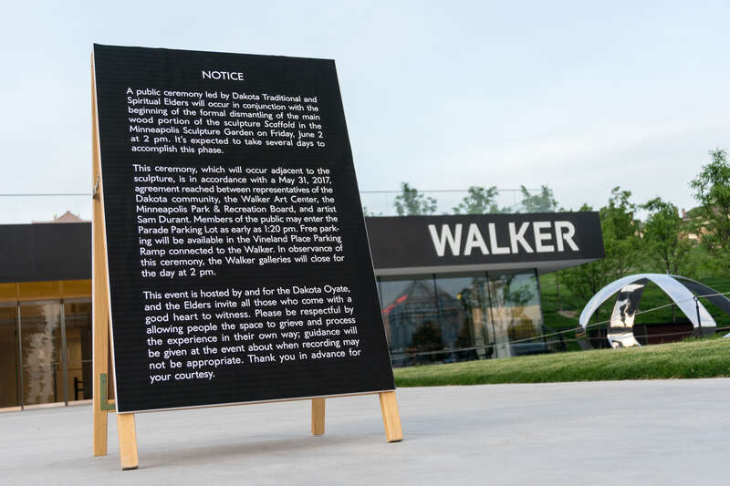 A sign that displays information about the Dakota Ceremony at the Walker Art Center.
Photograph by Lorie Shaull.
"Scaffold," a wood &amp; steel sculpture by the artist Sam Durant, was a composite of the representations of 7 historical gallows used in