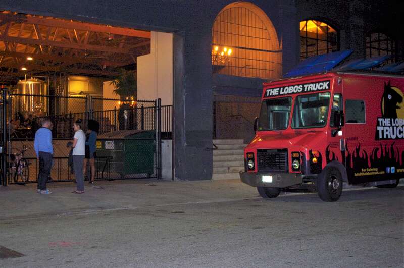 A late night group hang out at the entrance to the Iron Triangle Brewery in the Arts District of Los Angeles. This brewery among several others  the arts District could also be the "Brewery District"  !
